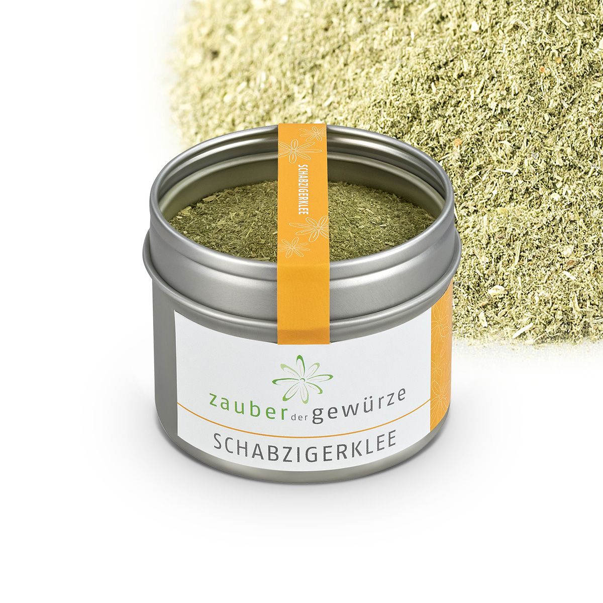 Dose Schabzigerklee mit Streuung. Metallbehälter mit weißem Etikett und orangefarbenem Band. Aufschrift: Zauber der Gewürze, Schabzigerklee.