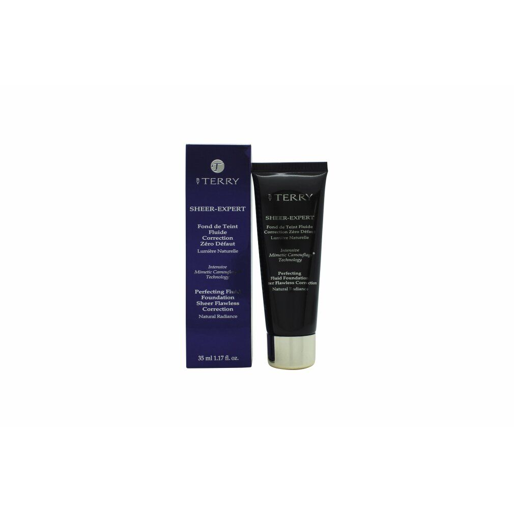 Dunkelblaue Tube und Schachtel. Aufschrift: Sheer-Expert, Fond de Teint Fluide, Perfecting Fluid Foundation. Goldfarbener Verschluss.