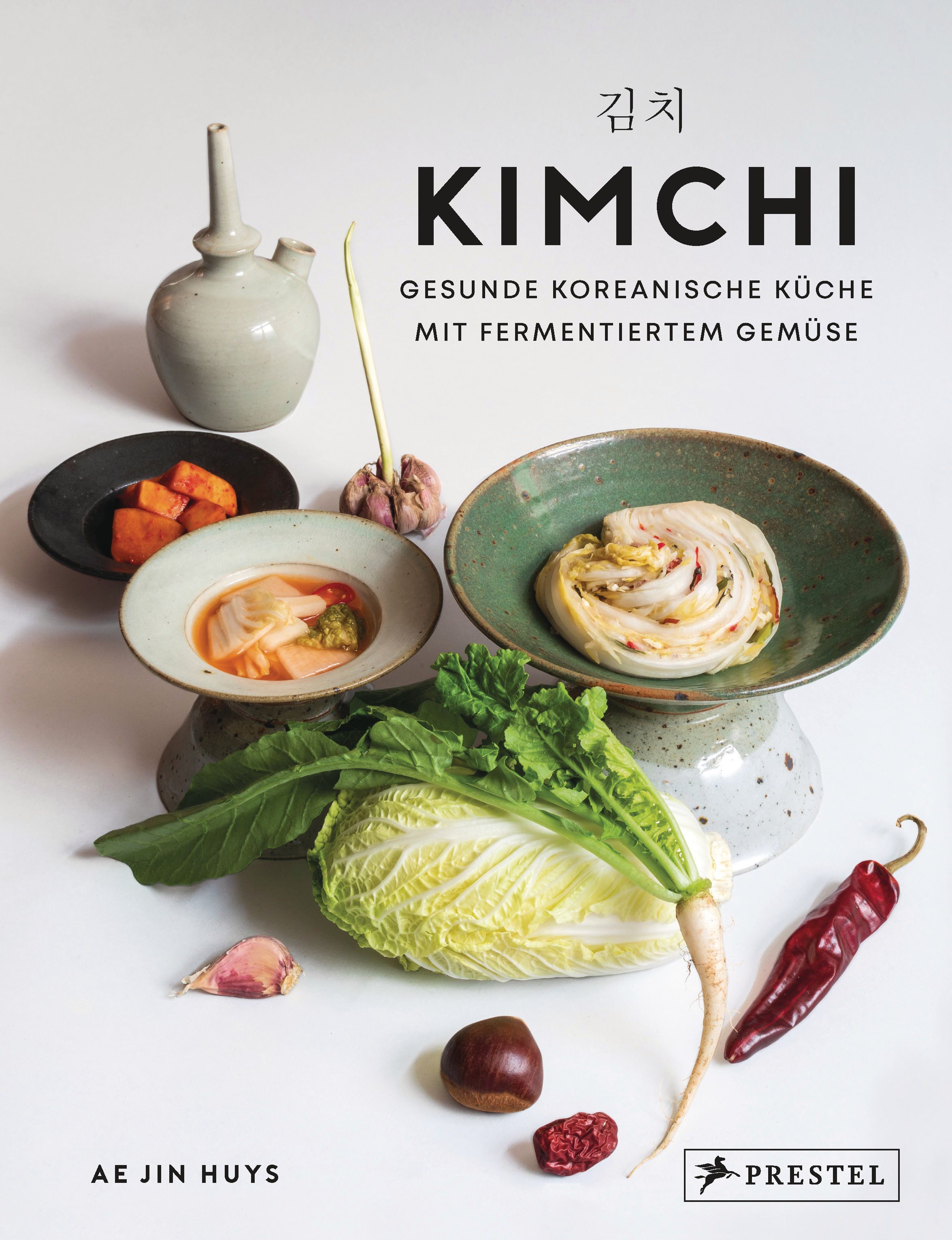 Buchcover mit dem Titel KIMCHI. Darunter: Gesunde koreanische Küche mit fermentiertem Gemüse. Daneben: Gemüse und Zutaten.