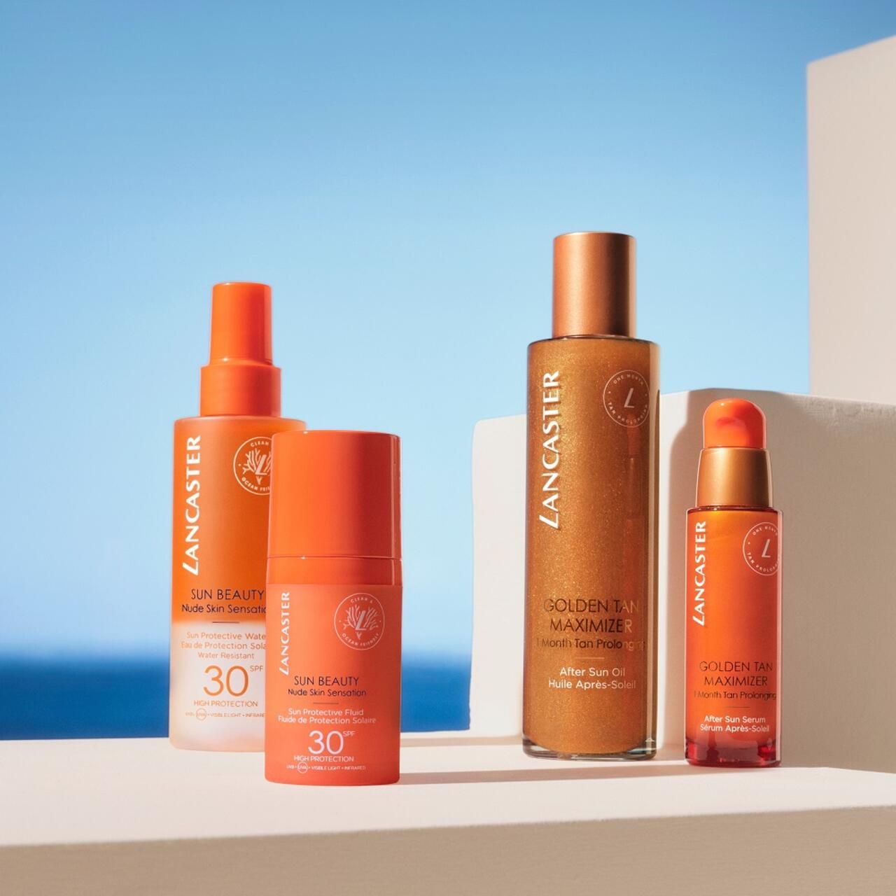Verschiedene Lancaster-Produkte. Sonnencreme, After Sun Öl und Serum. Orangefarbene Flaschen. Text: SPF 30, Golden Tan Maximizer.