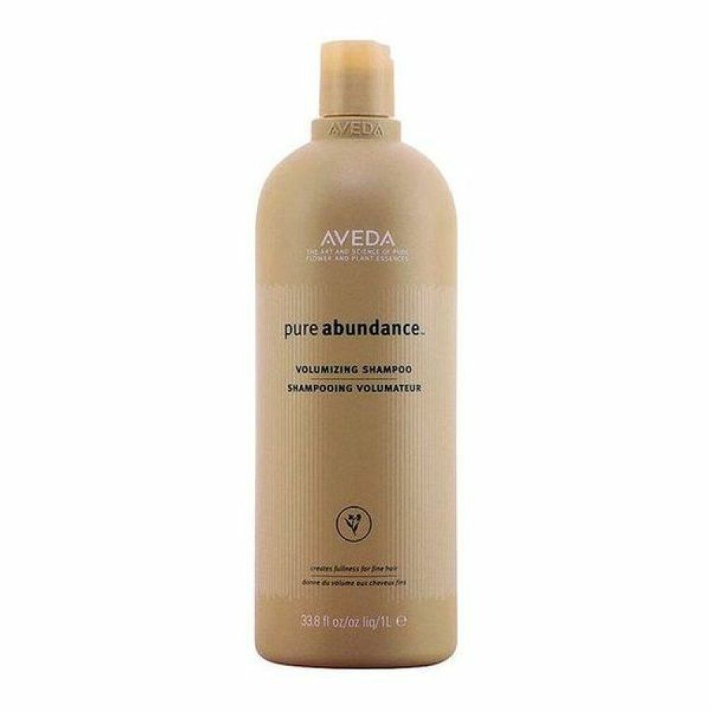 Beige Flasche mit Aveda-Logo und Produktnamen. Text: Pure Abundance Volumizing Shampoo. Grüne Pflanzen-Illustration.
