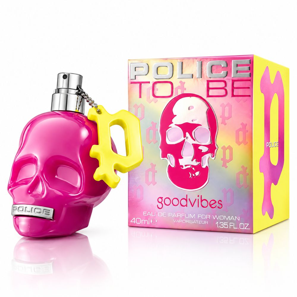 Pinke Totenkopf-Parfümflasche mit gelbem Anhänger und passender Schachtel.