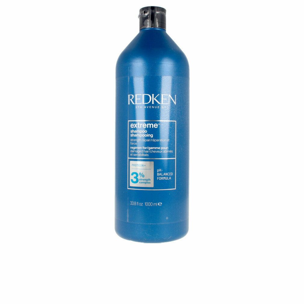 Blaue Flasche Redken Extreme Shampoo. Schwarzer Deckel. Text: Extreme Shampoo, pH-ausgewogene Formel, 1000 ml.