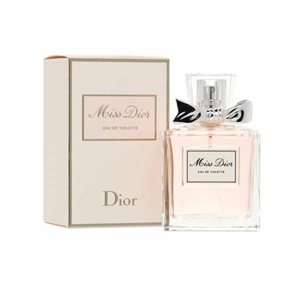Parfümflasche und Schachtel. Flasche mit rosa Flüssigkeit, silberner Schleife und Aufschrift Miss Dior. Schachtel daneben.