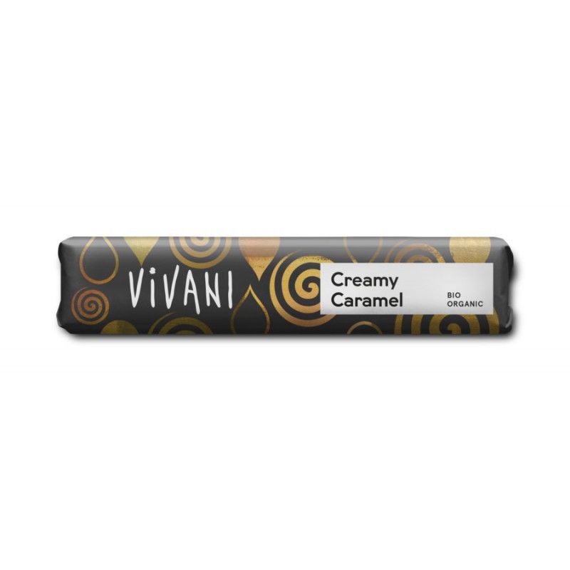 Verpackung eines Riegels mit dem Logo "Vivani". Aufschrift "Creamy Caramel" und "Bio Organic". Schwarzer Hintergrund mit goldenen Mustern.
