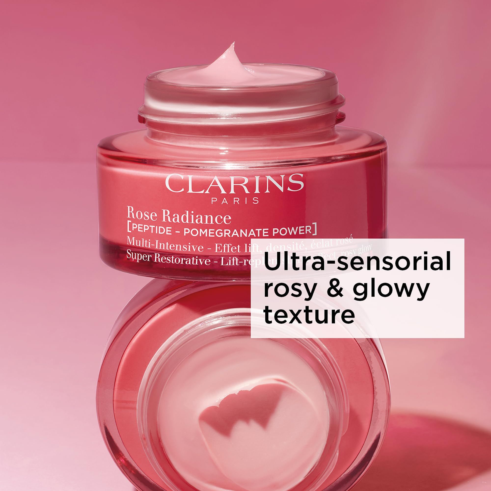 Rote Creme-Dose mit Deckel, Creme auf dem Deckel. Aufschrift: CLARINS PARIS, Rose Radiance, [PEPTIDE - POMEGRANATE POWER].