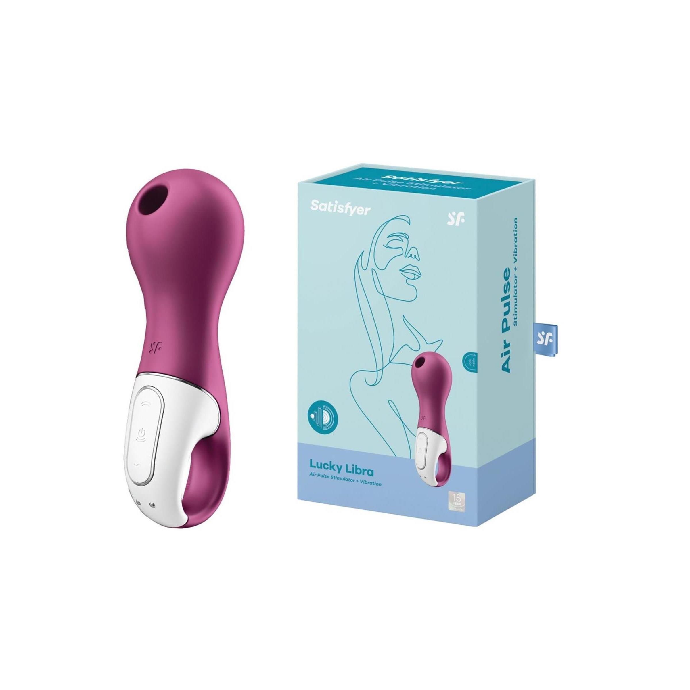 Lila-weißes Wellness-Produkt mit abgerundeter Form und Ring. Verpackung mit Produktabbildung und Schriftzug "Satisfyer Lucky Libra".