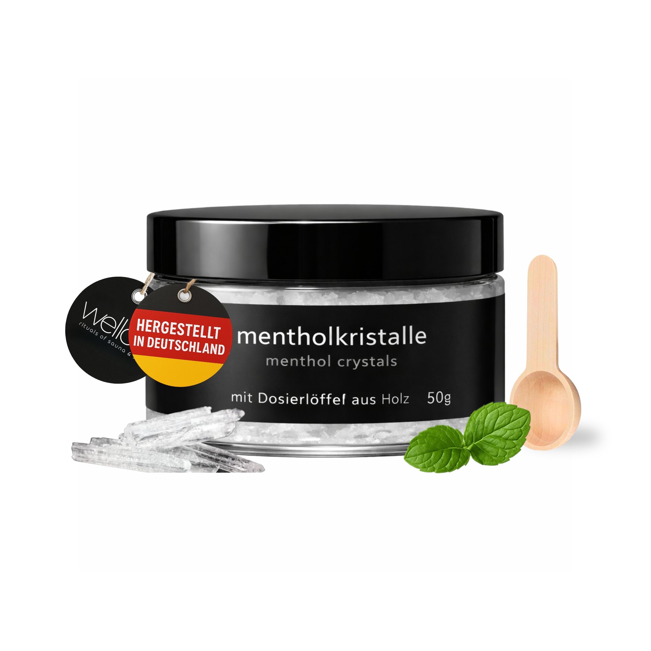 Produkt mit Holzlöffel, Kristallen und Minzblättern. Dose mit Aufschrift: mentholkristalle, 50g, hergestellt in Deutschland.