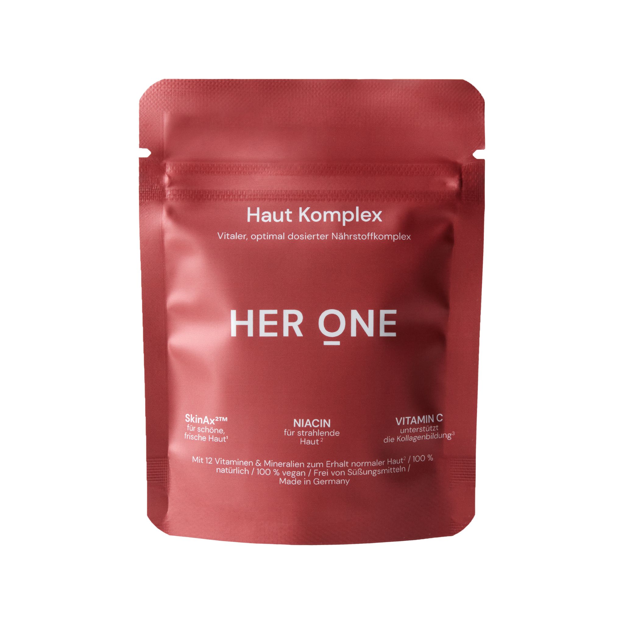 Rote Verpackung mit der Aufschrift "Haut Komplex" und "HER ONE". Enthält Nährstoffkomplex. Enthält SkinAx, Niacin und Vitamin C. Hergestellt in Deutschland.