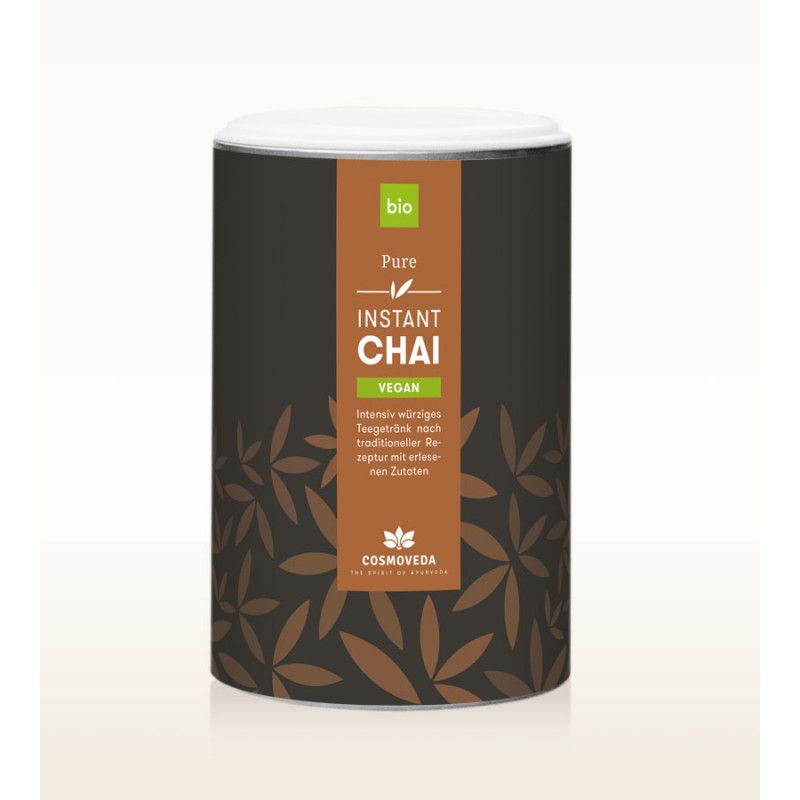 Zylindrische Dose mit Deckel. Aufschrift: BIO Instant Chai Vegan. Braune Blättermuster auf dunklem Hintergrund. Marke: Cosmoveda.