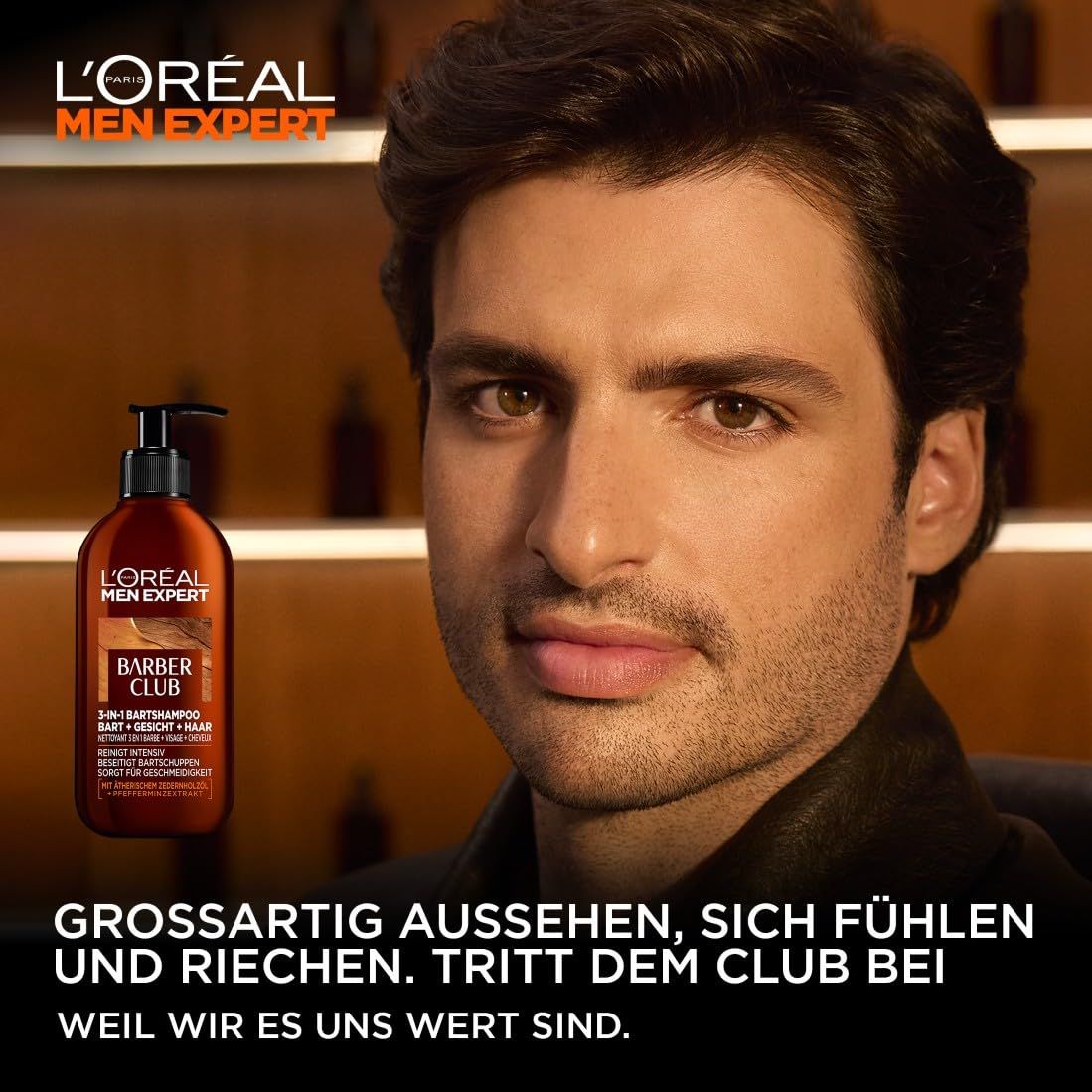 Mann hält L'Oréal Men Expert Barber Club 3-in-1 Bartshampoo. Braune Flasche mit schwarzem Pumpverschluss. Markenlogo.