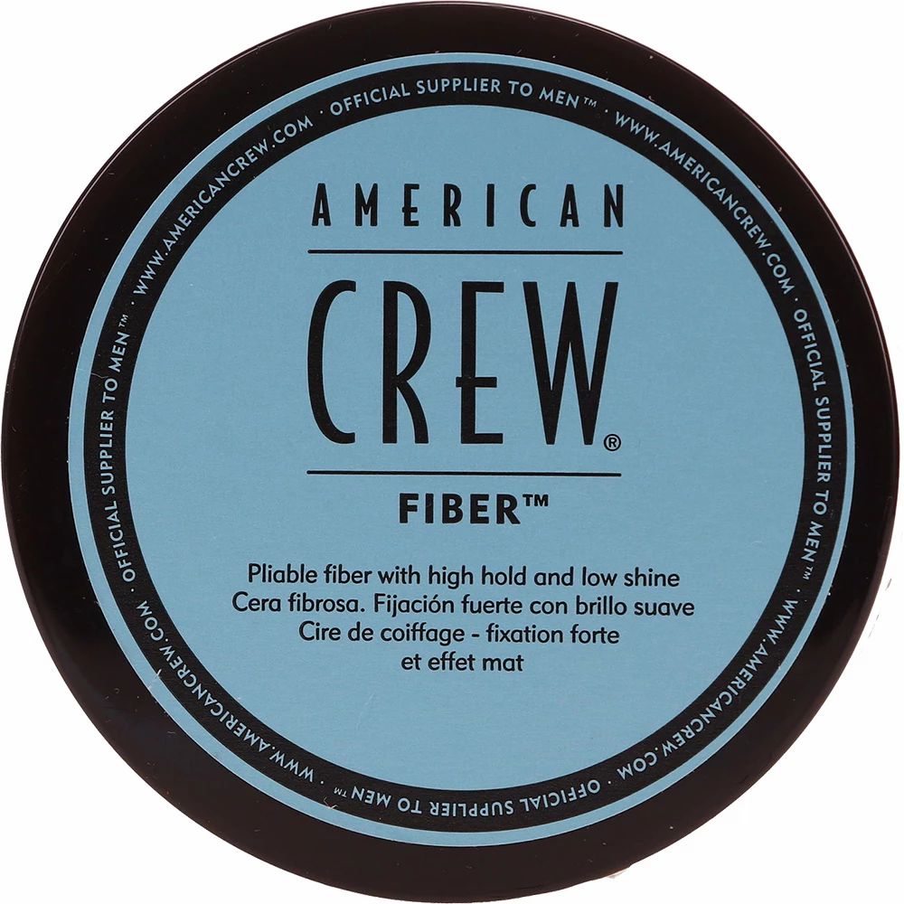 Runde Dose mit blauem Etikett. Aufschrift: AMERICAN CREW FIBER. Text in Englisch, Spanisch und Französisch.
