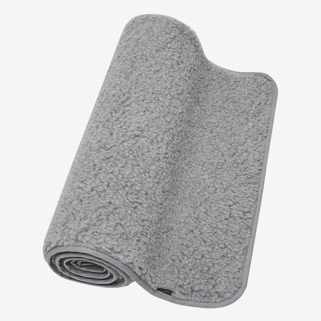 Graue Yogamatte aus Wolle, gerollt. Oberseite mit flauschiger Textur, grauer Rand. Teilweise sichtbar.