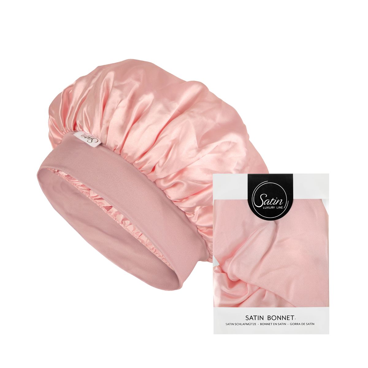 Een roze satijnen haarband en een verpakking. De verpakking toont de naam "Satin" en "Satin Bonnet". De haarband is gemaakt van glanzende stof.