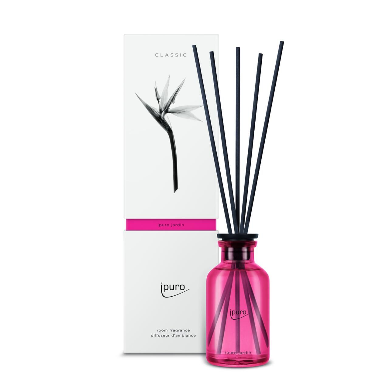Raumduft-Diffusor mit schwarzen Stäbchen und rosa Flasche. Verpackung mit Logo und floralem Motiv.