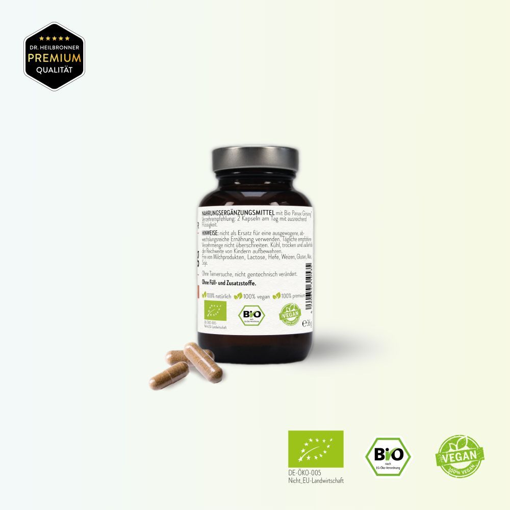 Braune Glasflasche mit weißem Etikett und Kapseln daneben. Aufschrift: Bio Ginseng, 15% Ginsenoside, PANAX, 60 Kapseln. Vegan.