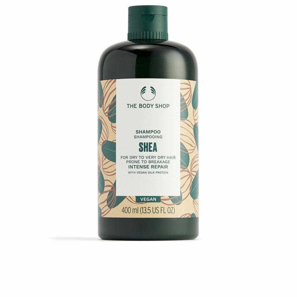 Dunkelgrüne Shampoo-Flasche mit weißem Etikett. Aufschrift: Shea, Shampoo, Vegan. 400 ml.