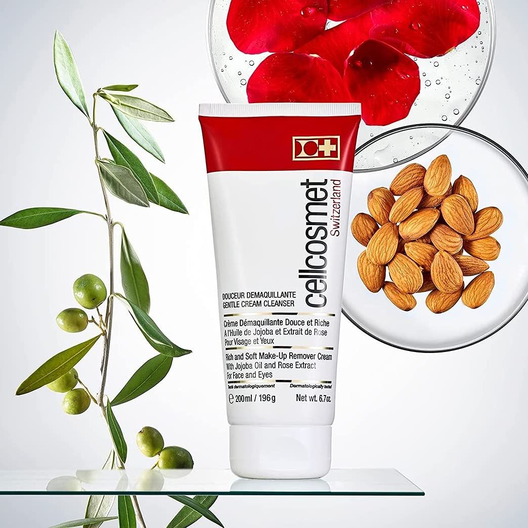 Creme-Reiniger-Tube mit Olivenzweig, Rosenblättern und Mandeln. Produktname und Marke sichtbar.