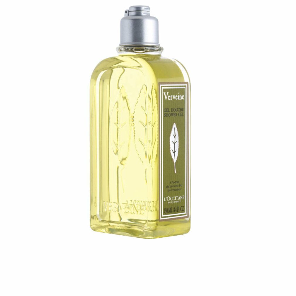 Gelbe Flüssigkeit in einer rechteckigen Flasche mit silbernem Deckel. Aufschrift: Verbene, Gel Douche, L'Occitane. Blattrelief.