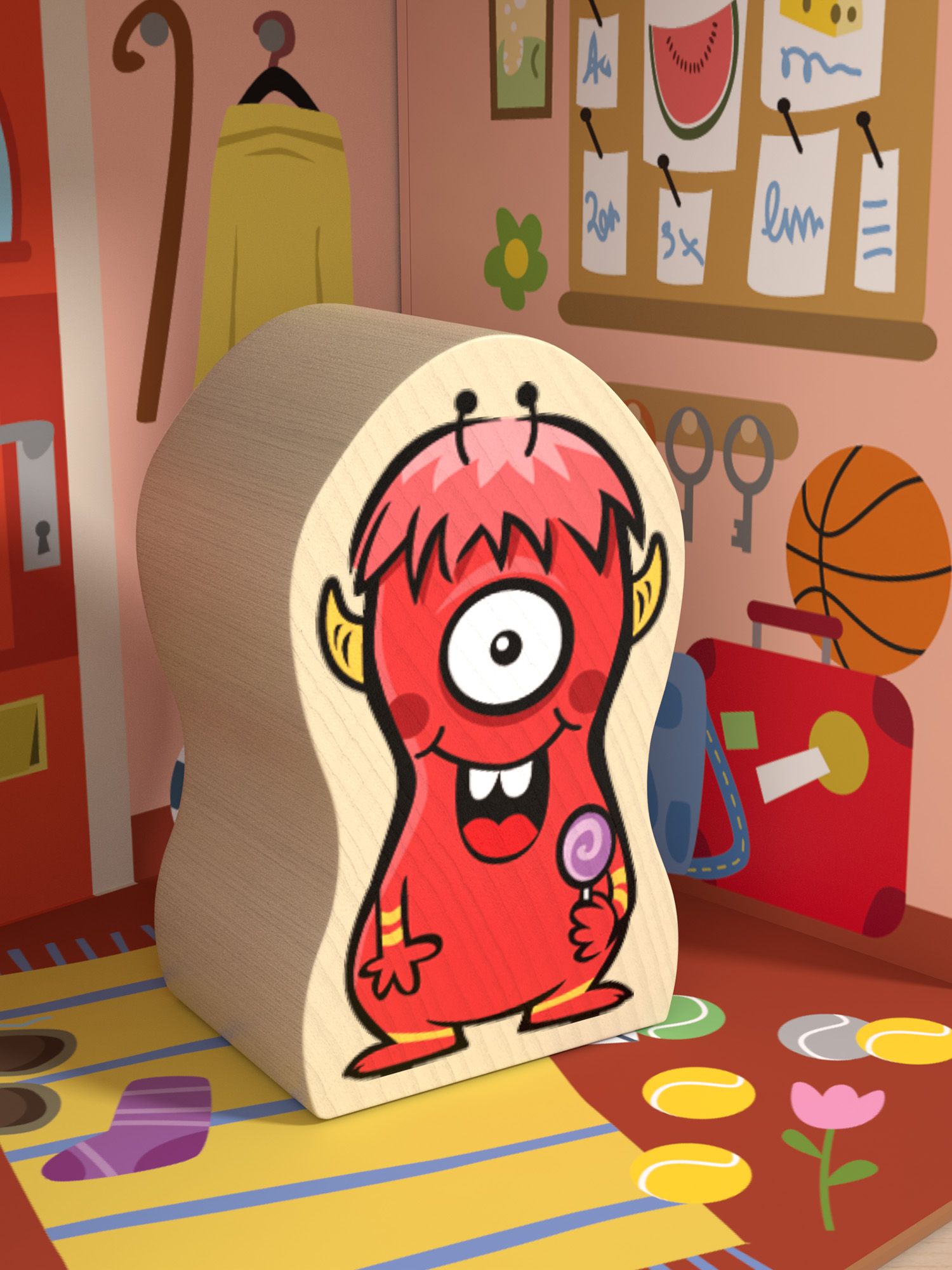 Holzfigur eines roten Monsters mit einem Auge und einem Lolli. Es steht in einem Zimmer mit Möbeln und Dekorationen.