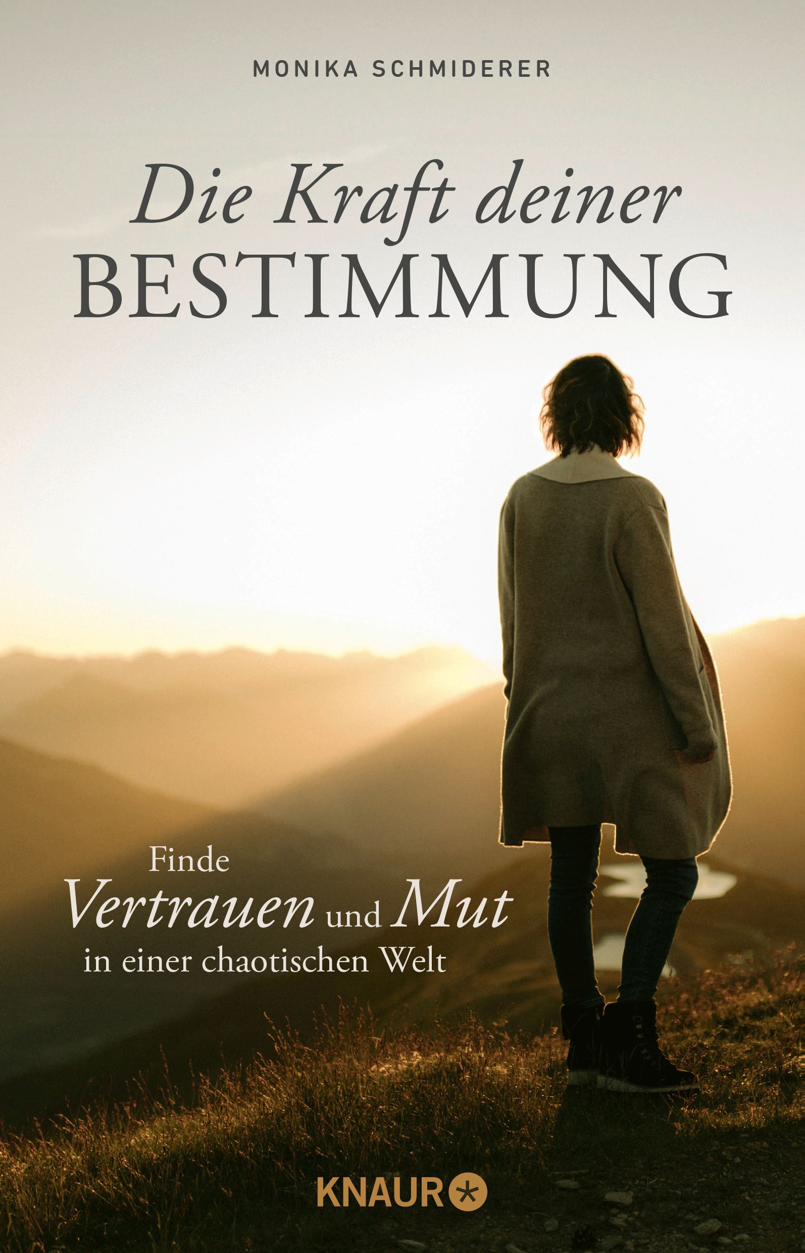 Buchcover mit Titel: Die Kraft deiner Bestimmung. Frau blickt in Landschaft. Autorin: Monika Schmiderer. Verlag: Knaur.