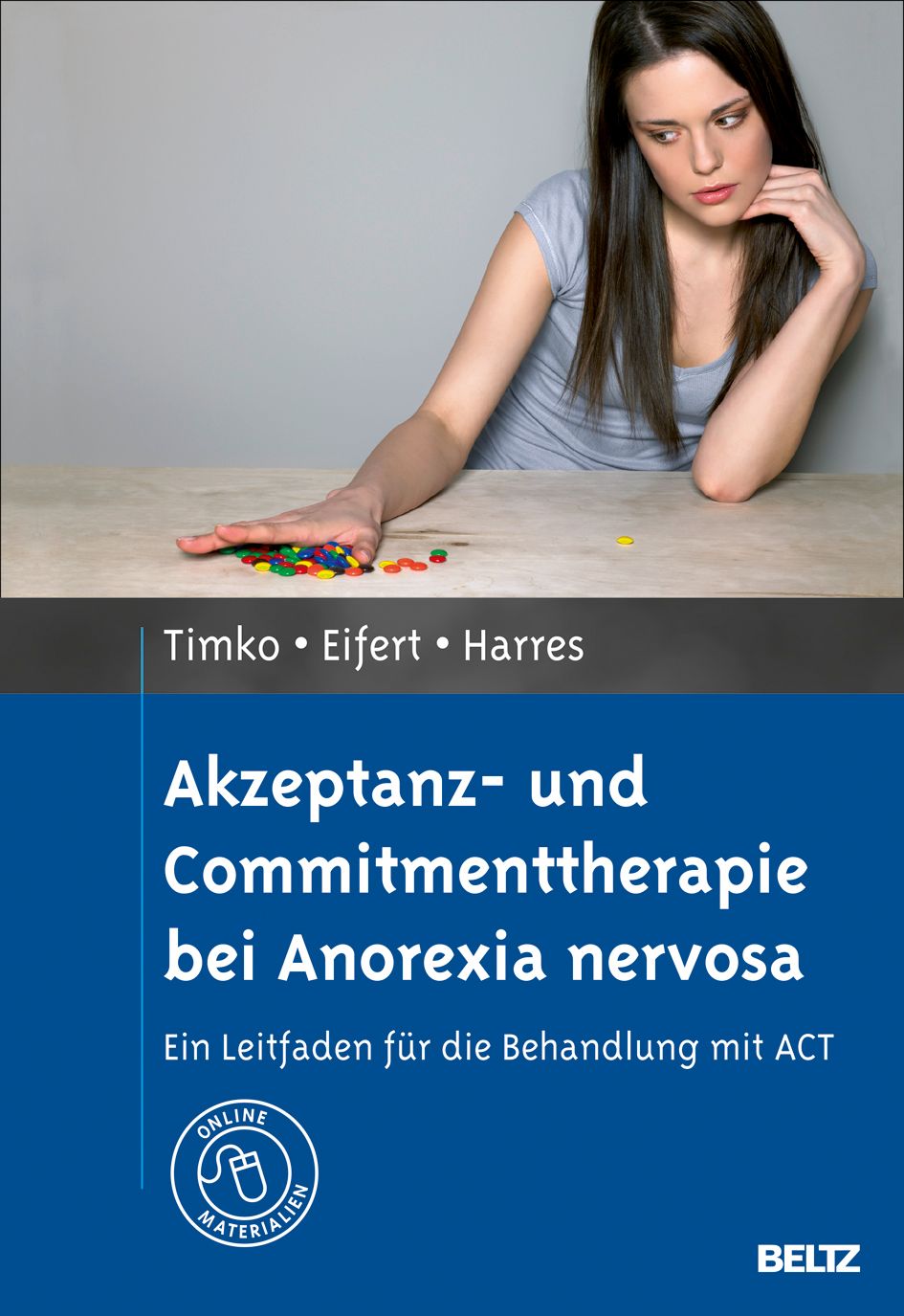 Buchcover: Akzeptanz- und Commitmenttherapie bei Anorexia nervosa. Titel und Autoren. Frau am Tisch mit farbigen Steinen.