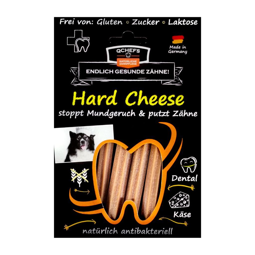 Schwarze Verpackung mit QCHEFS Hard Cheese. Enthält Text: 'Endlich gesunde Zähne!' und 'stoppt Mundgeruch & putzt Zähne'.