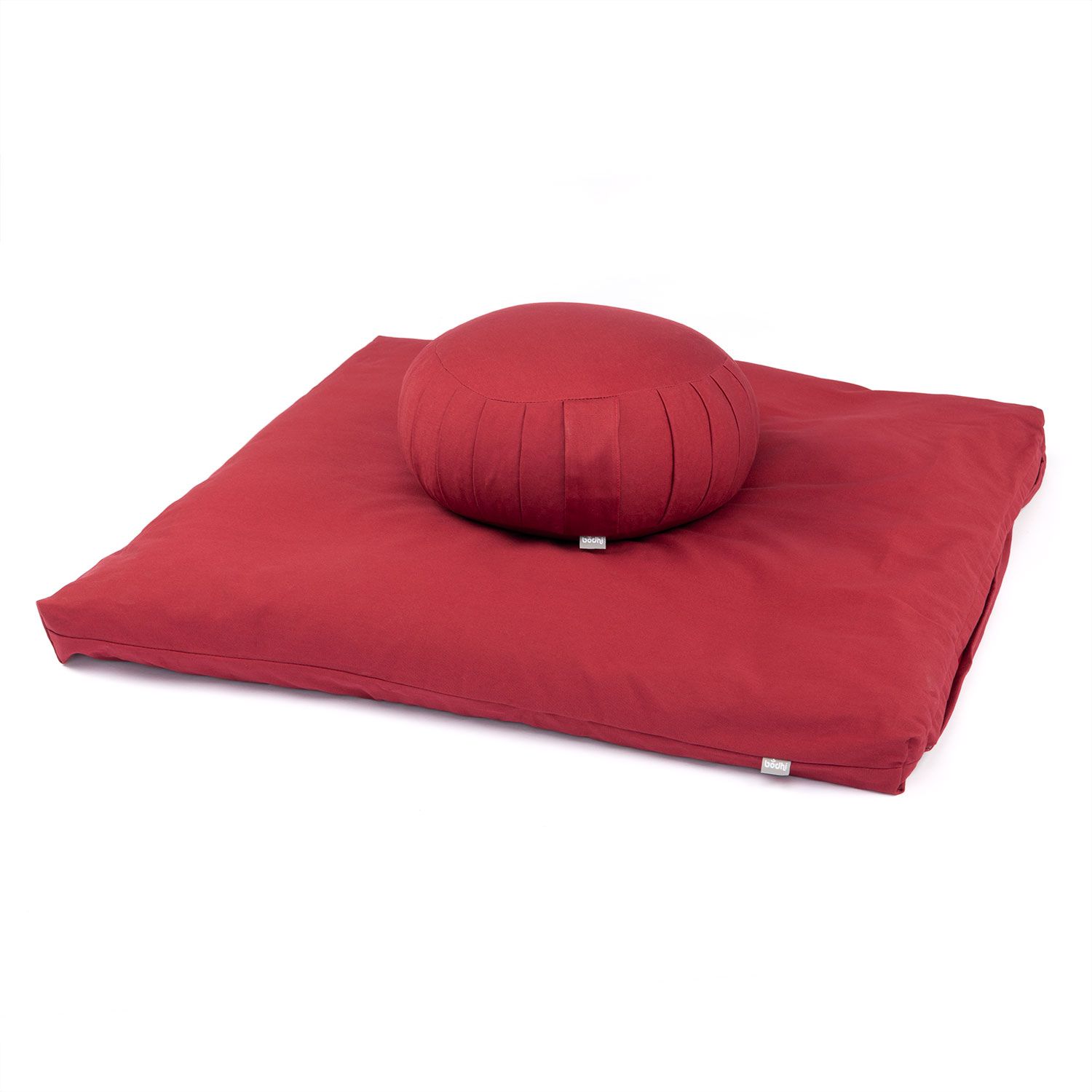 Rotes Meditationskissen ZAFU und Matte ZABUTON. Rundes Kissen auf quadratischer Matte. Stoffbezug, Falten am Kissen.