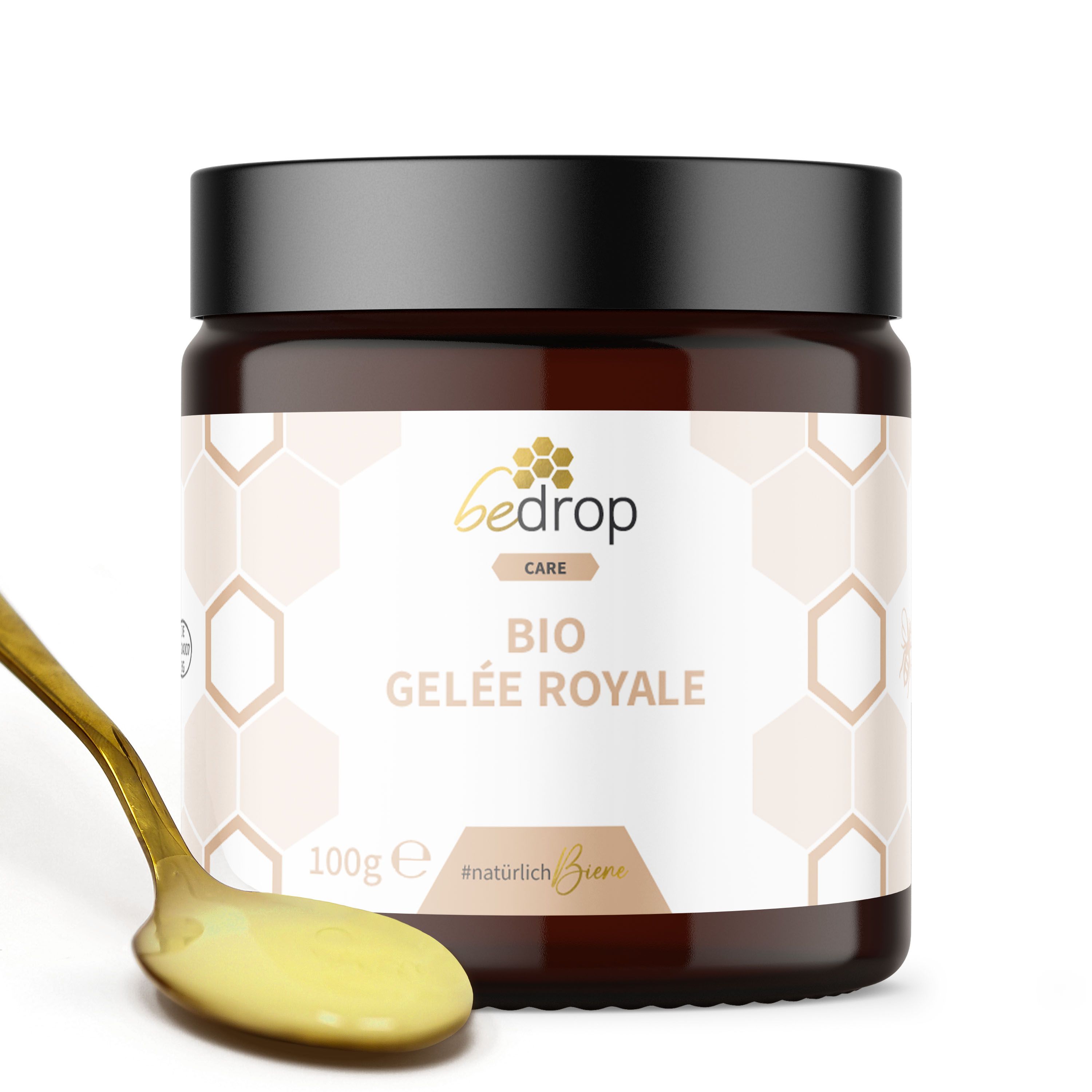 Braunes Glas mit schwarzem Deckel. Aufkleber mit Schriftzug 'bedrop CARE BIO GELÉE ROYALE'. Löffel mit gelbem Inhalt.