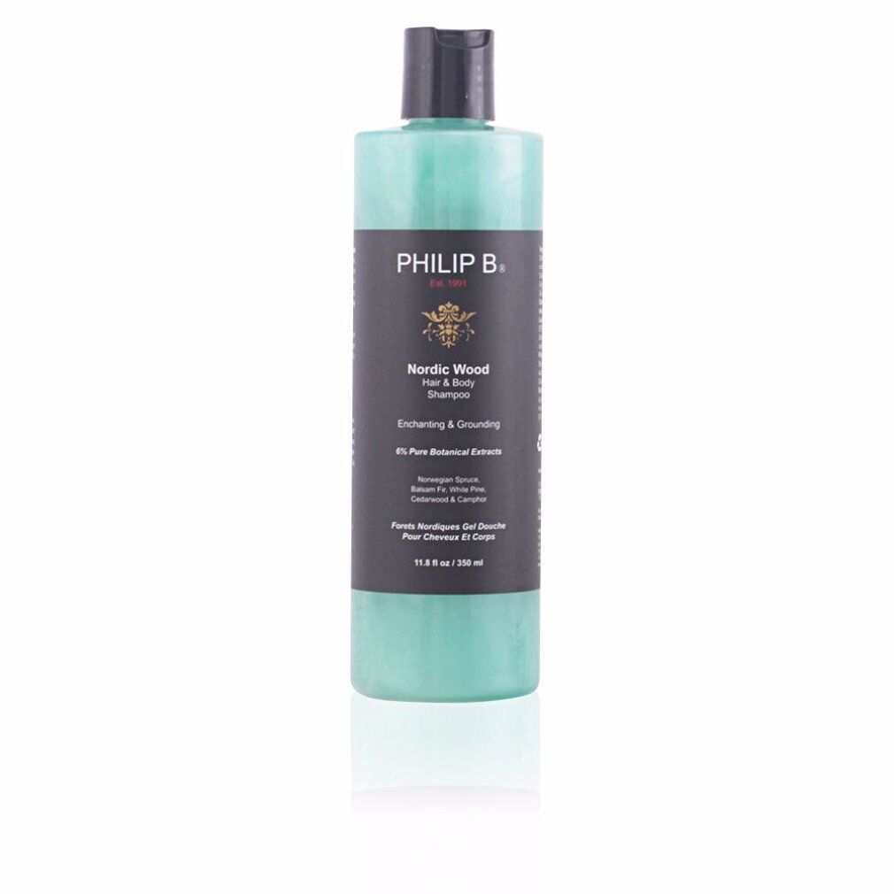 Flasche mit schwarzem Deckel. Aufschrift: PHILIP B. Nordic Wood Hair & Body Shampoo. Grünliche Flüssigkeit sichtbar. Text: Enchanting & Grounding.