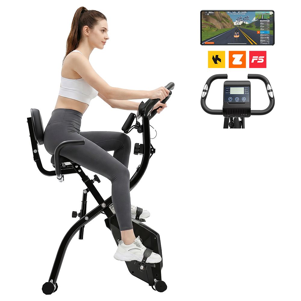 Frau auf schwarzem Heimtrainer. Display mit Trainings-App. Z, F5 Logos. Schwarzer Heimtrainer mit Sitz und Griffen.