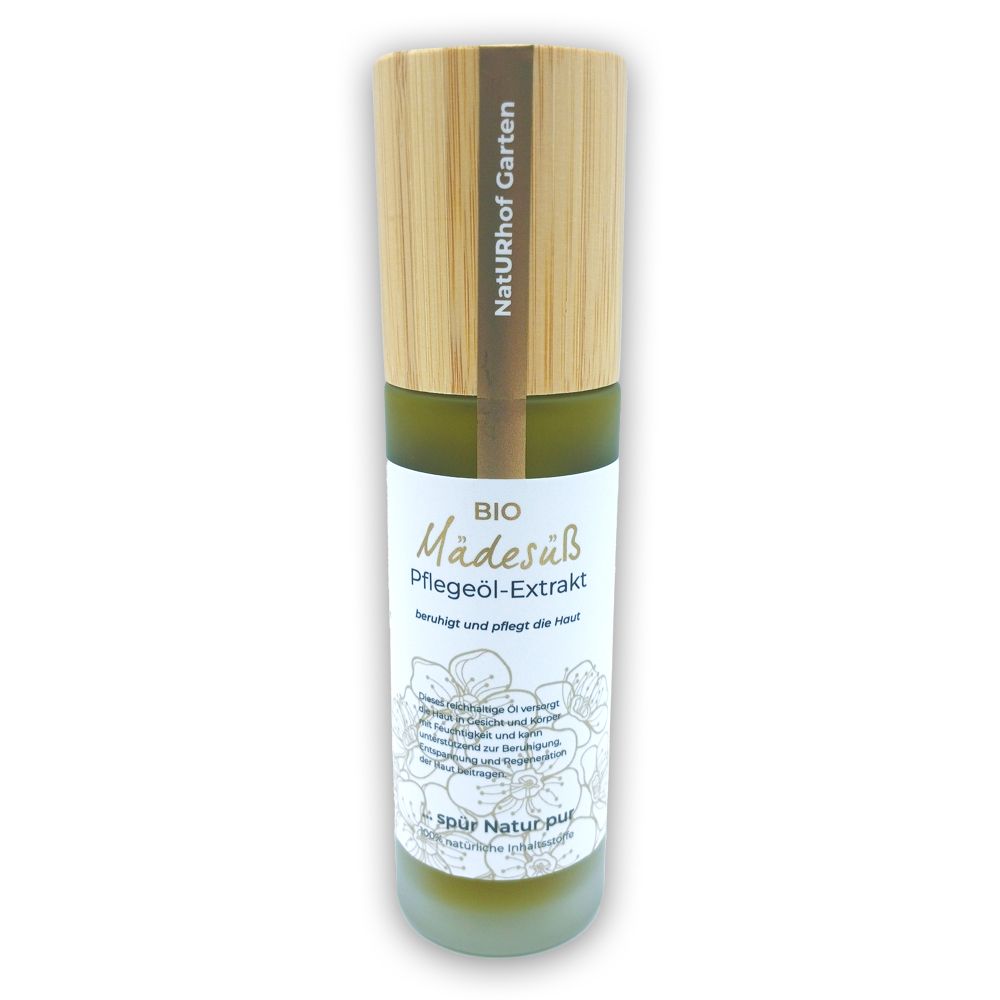 Zylindrische Flasche mit Holzdeckel. Aufschrift: BIO Mädesüß Pflegeöl-Extrakt. Etikett mit floralem Muster. NatURhof Garten.