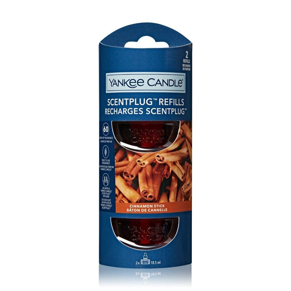 Yankee Candle Scentplug Nachfüllpackung. Zwei Nachfüllungen in zylindrischer Verpackung. Zimt-Sticks-Motiv. Blaue und braune Farben.