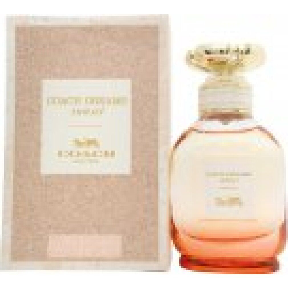 Parfümflakon und Verpackung. Auf der Verpackung steht "COACH DREAMS sunset". Der Flakon hat einen goldfarbenen Deckel und rosa-orangefarbene Farbverlauf.
