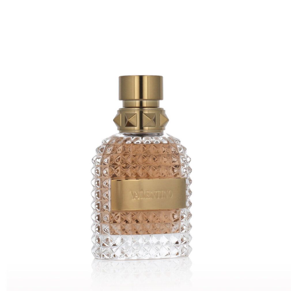 Valentino Uomo Eau de Toilette. Glasflakon mit goldfarbenem Verschluss und Label. Geprägtes Glas.