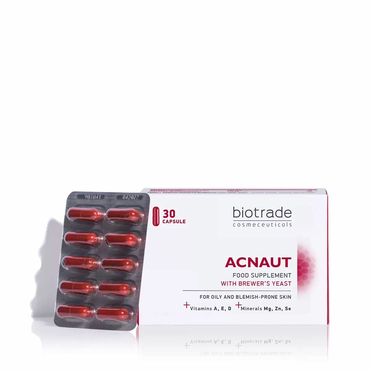 Blisterpackung mit roten Kapseln und Schachtel mit Aufschrift "Acnaut".
