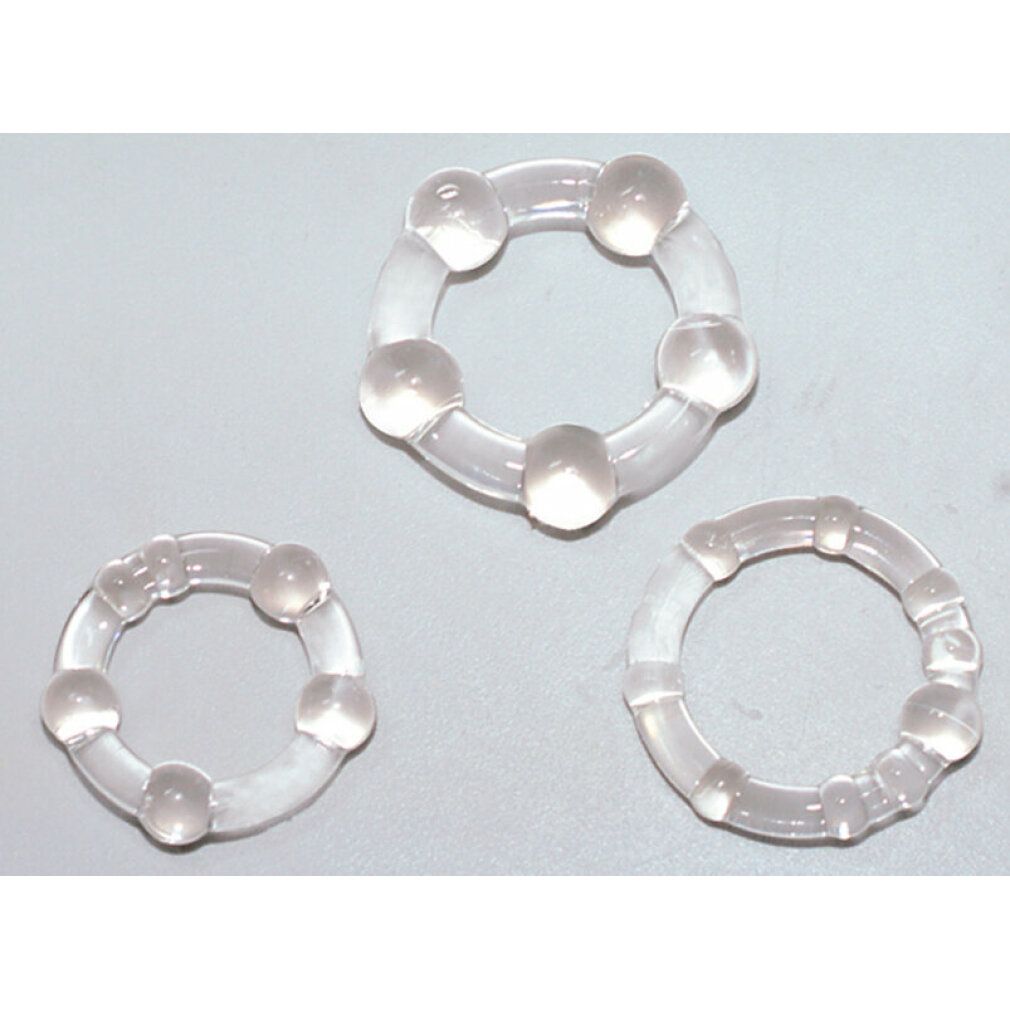 Drei transparente Penisringe mit unterschiedlichen Designs. Sie sind aus Silikon gefertigt und haben eine runde Form.
