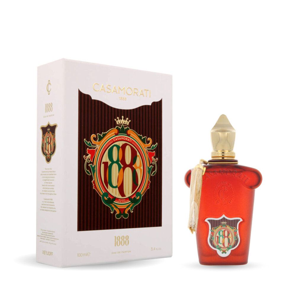 Rote Flasche mit goldener Kappe und Quaste, neben weißer Schachtel mit Logo und Schrift.