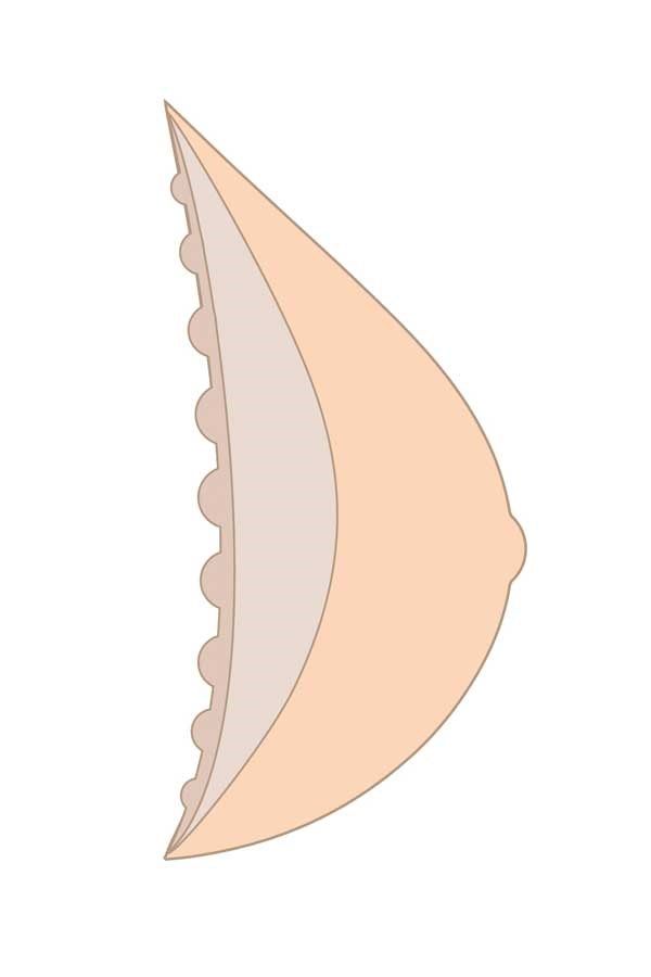Seitenansicht einer Brustprothese. Dreieckige Form mit abgerundeter Spitze. Auf einer Seite kleine, runde Erhebungen.