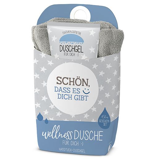 Wellness-Geschenkset mit Handtuch und Duschgel. Verpackung mit Sternenmuster und Text: Schön, dass es dich gibt.
