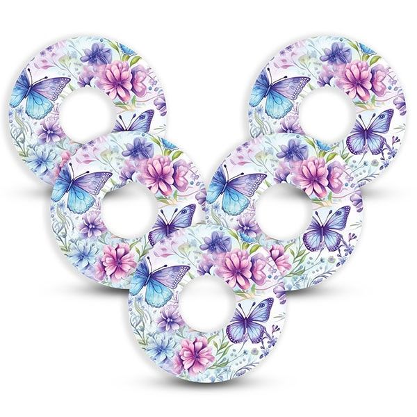 Fünf runde Fixierpflaster mit floralem Muster und Schmetterlingen.