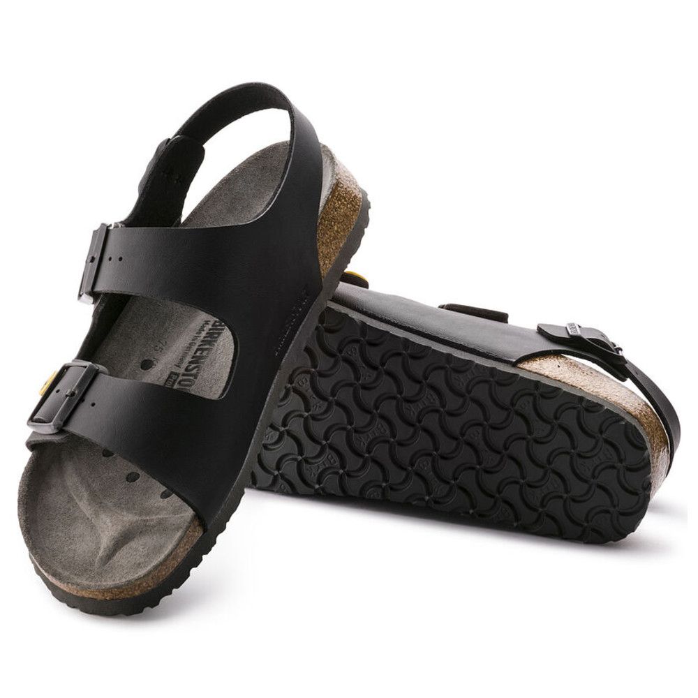 Schwarze Birkenstock Milano Sandalen, eine mit der Sohle nach oben. Deutlich sichtbar: Schnallen und Logo.