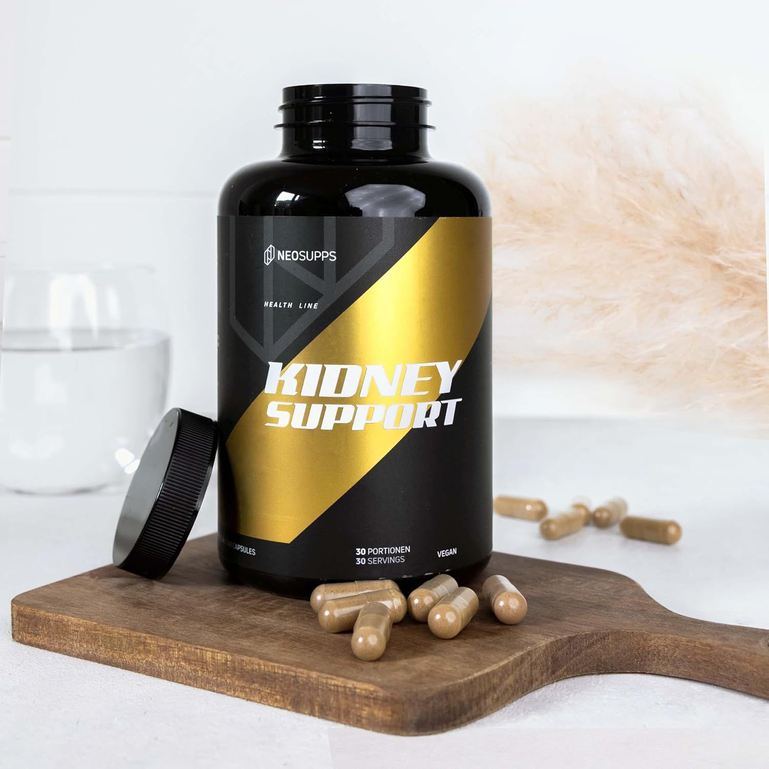 Schwarze Flasche mit gelbem Etikett. Aufschrift: Kidney Support, Neosupps. Geöffnete Flasche, Kapseln auf Holzbrett. Vegan.