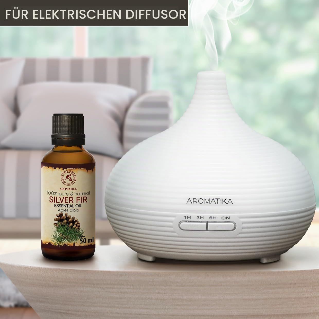 Flasche Silber-Tanne-Ätherisches Öl neben elektrischem Diffusor.