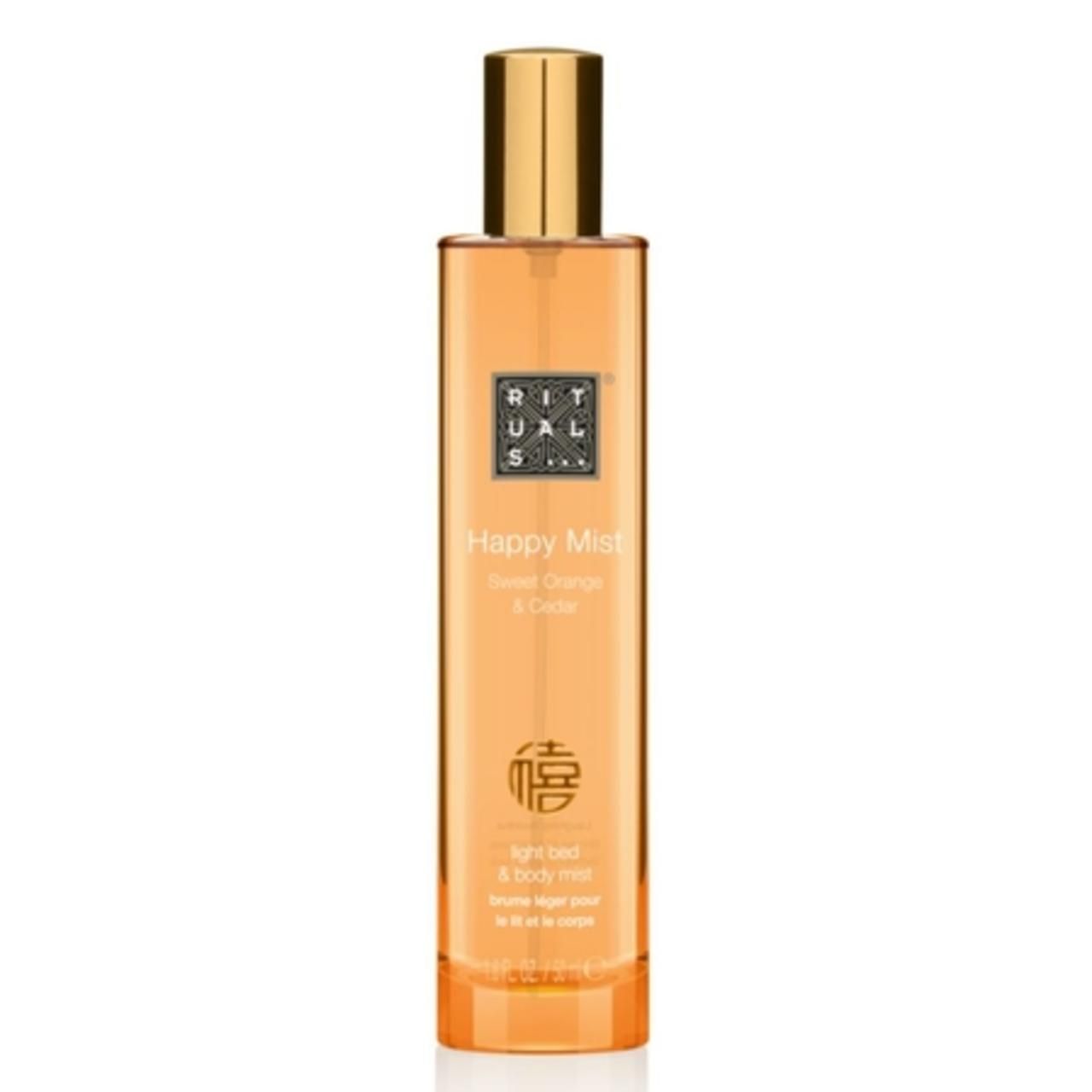 Klarer, orangefarbener Flakon mit goldenem Deckel. Aufschrift: Happy Mist, Sweet Orange & Cedar. Marke Rituals.