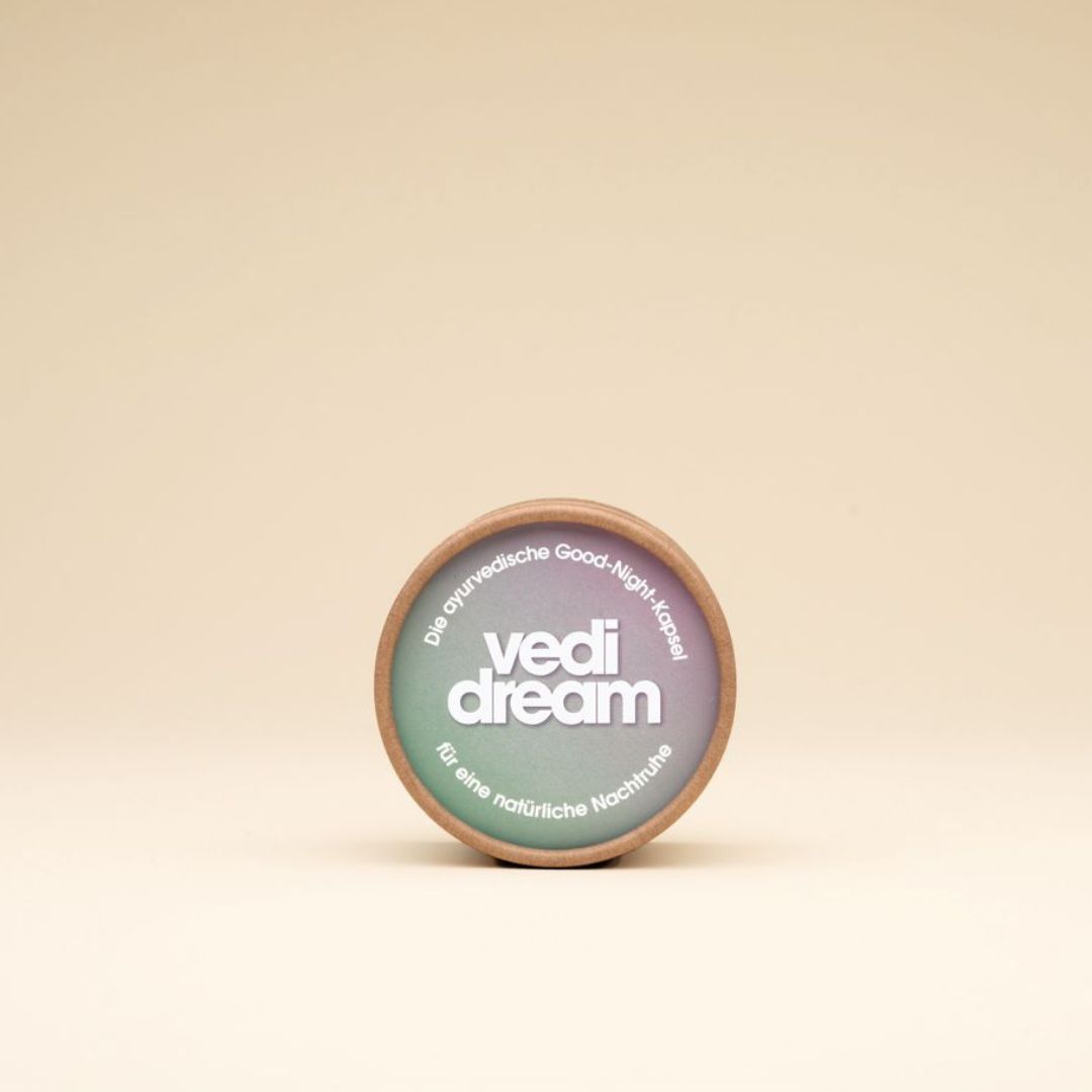 Runde Produktverpackung mit Logo: vedi dream. Verpackung aus Pappe. Farbverlauf von grün nach lila.