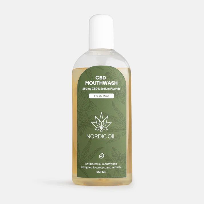Klare Flüssigkeit in einer Flasche mit grünem Etikett. Etikett mit Text: CBD Mouthwash, Nordic Oil, 250mg CBD & Sodium Fluoride.