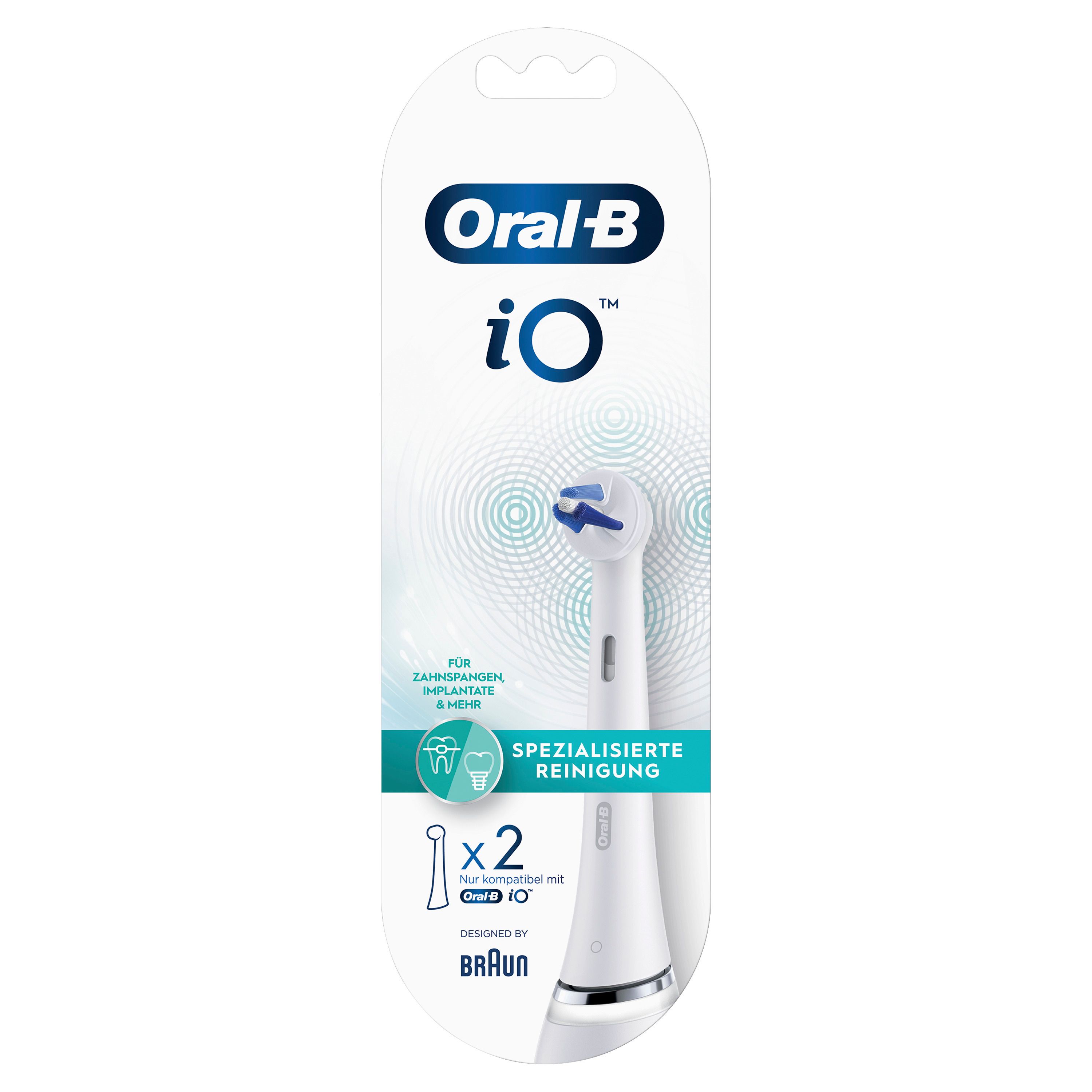 Verpackung mit zwei Aufsteckbürsten. Marke Oral-B iO. Spezialisierte Reinigung. Weiße Bürstenköpfe mit blauen Borsten. Braun Logo.