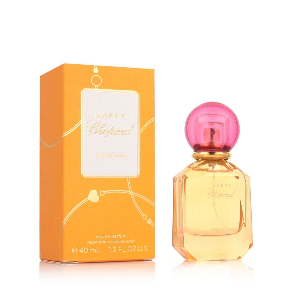 Parfümflasche und Verpackung. Flasche mit rosa Kappe, gelber Flüssigkeit. Verpackung orange mit weißem Etikett.