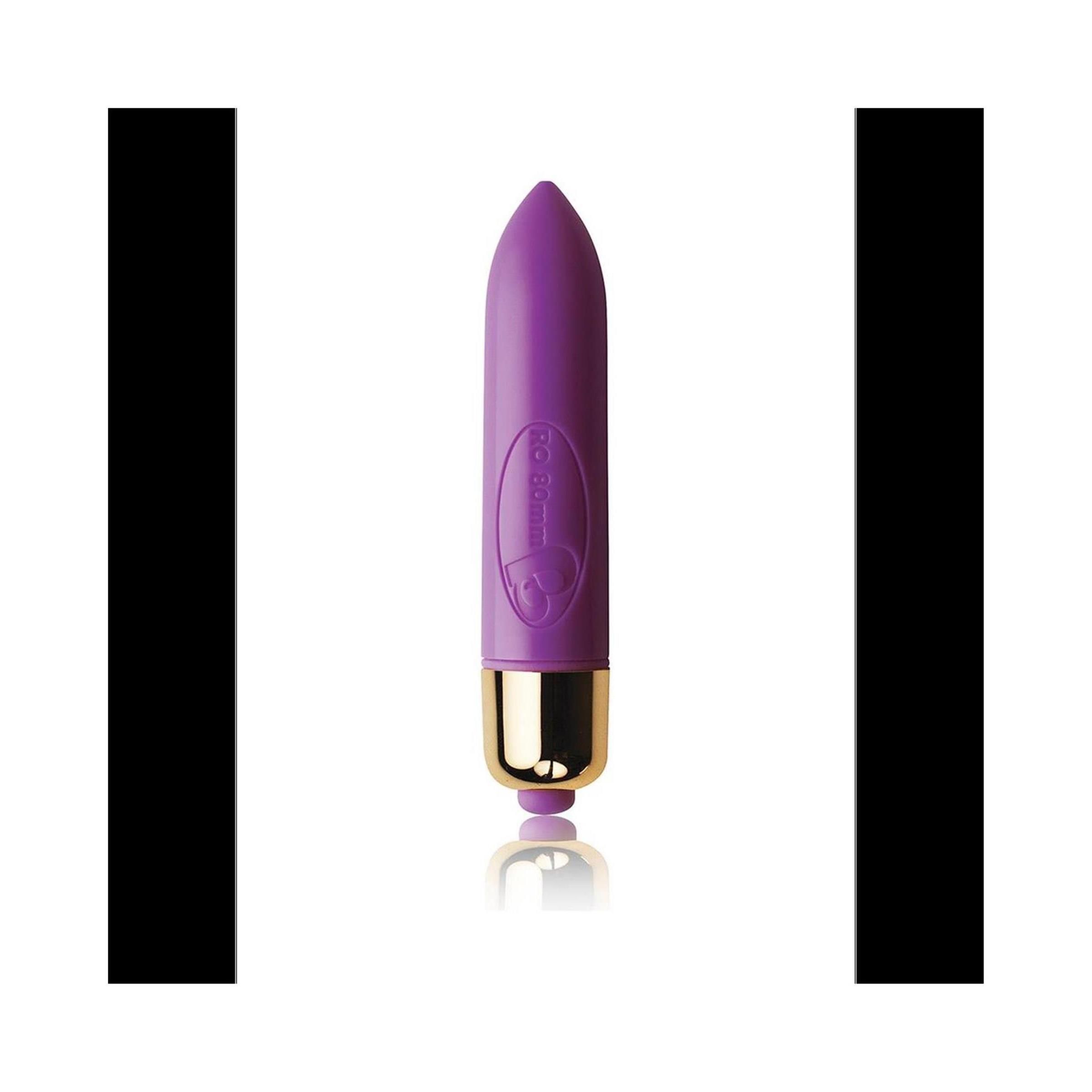 Lila Vibrator mit goldfarbenem Ende. Kegelförmig, glatte Oberfläche.